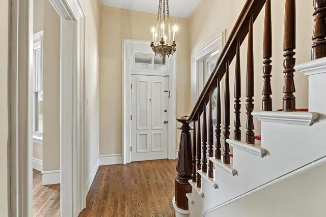 a living room with furniture a chandelier and a window