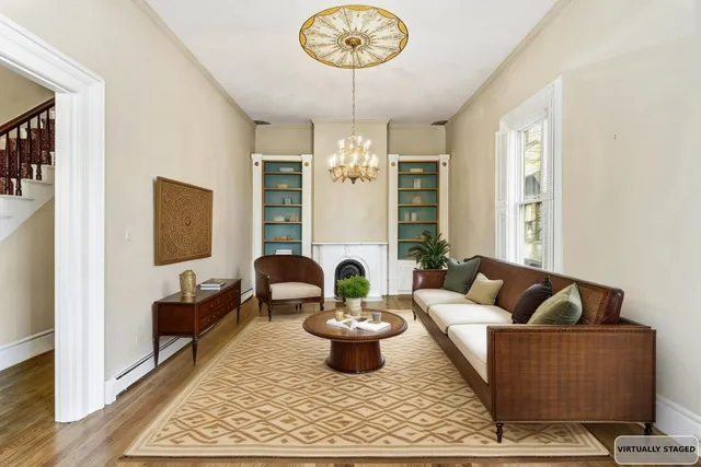 a view of a room with chandelier fireplace and windows