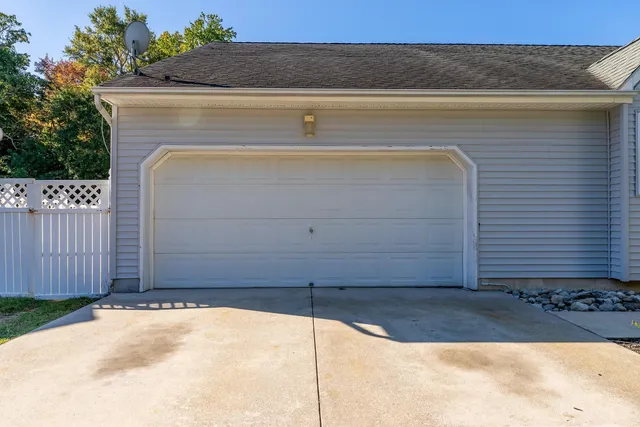 a view of a house with a yard and sitting area