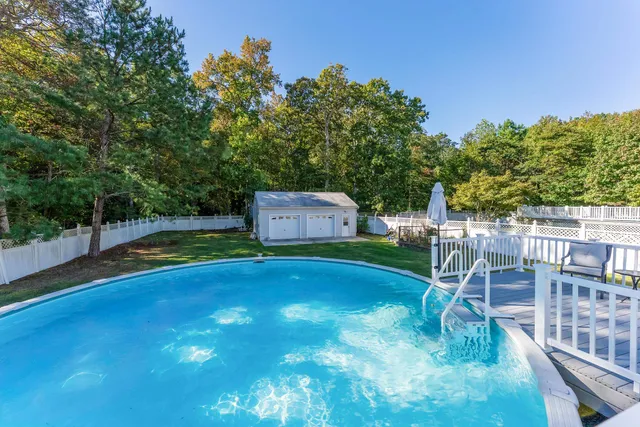 a view of a backyard with swimming pool