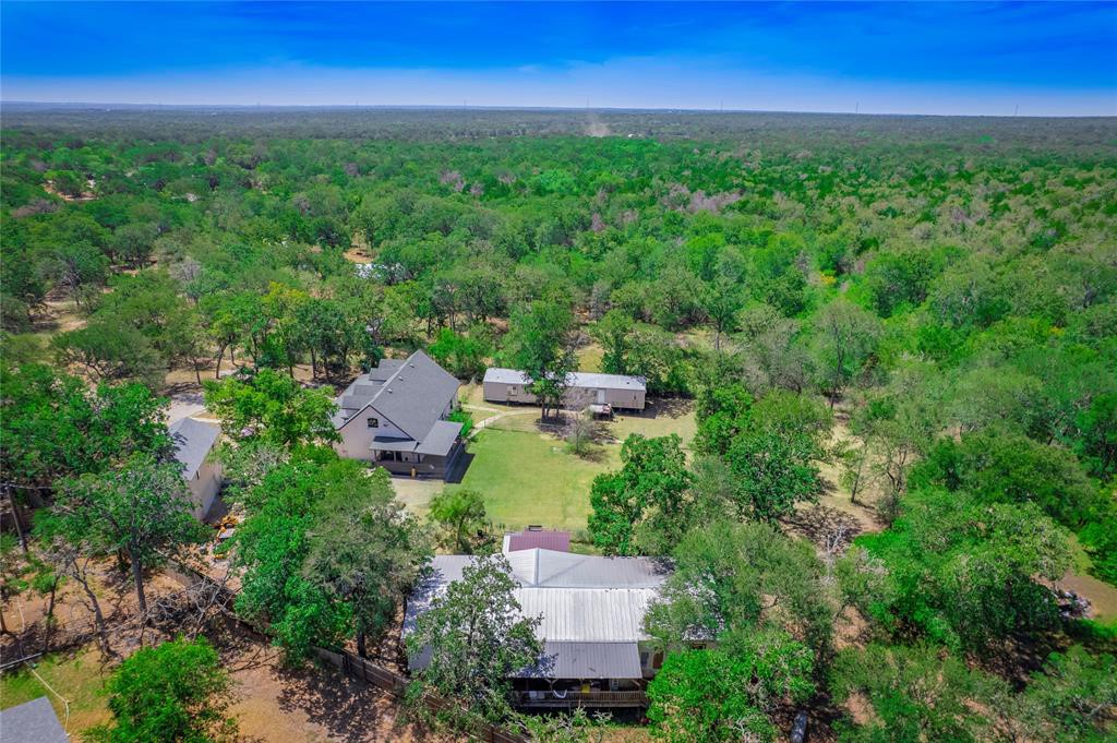 an aerial view of a house with garden space and street view