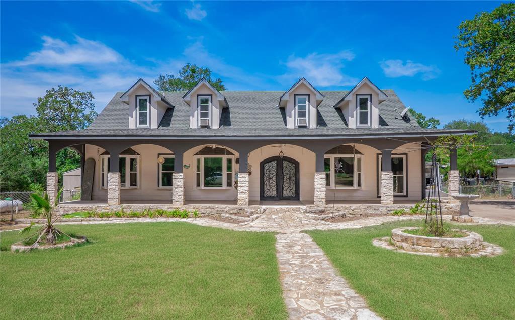 368 Riddle Road Cedar Creek, TX 78612 - Photo 2 of 16 a front view of a house with a yard