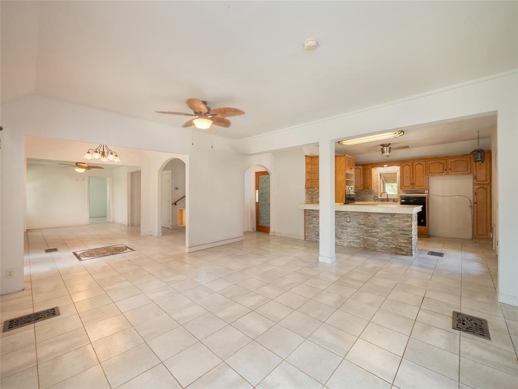 368 Riddle Road Cedar Creek, TX 78612 - Photo 6 of 16 a view of a kitchen with furniture and a chandelier fan