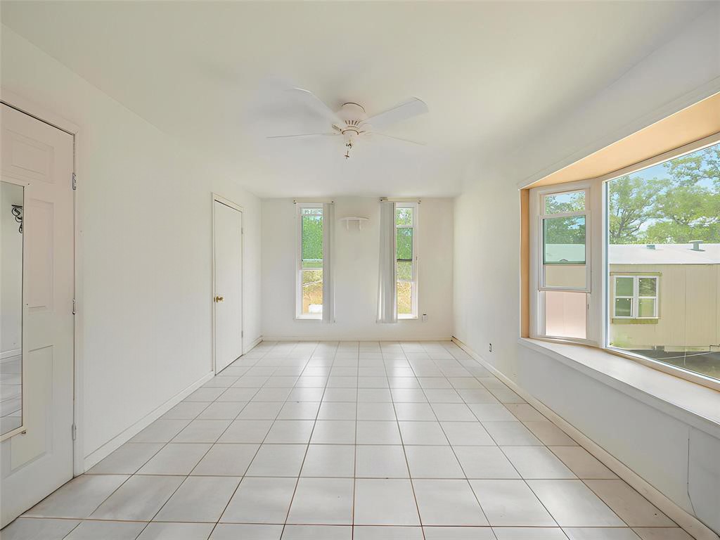 368 Riddle Road Cedar Creek, TX 78612 - Photo 8 of 16 a view of an empty room with a window
