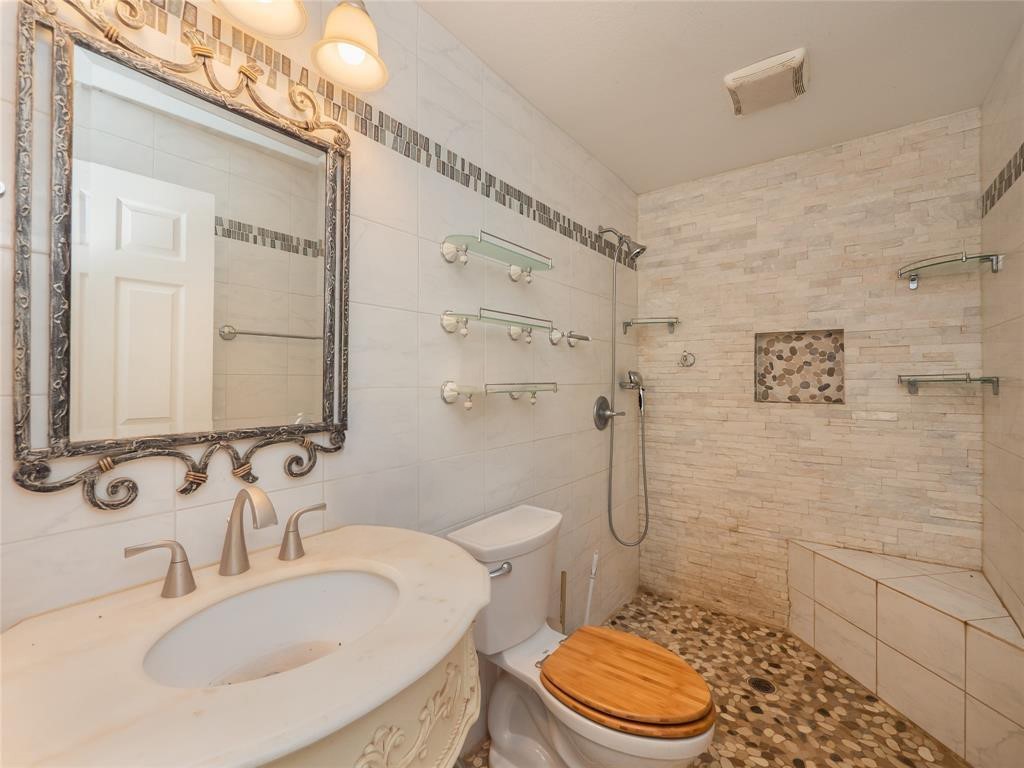 368 Riddle Road Cedar Creek, TX 78612 - Photo 9 of 16 a bathroom with a sink a toilet and shower