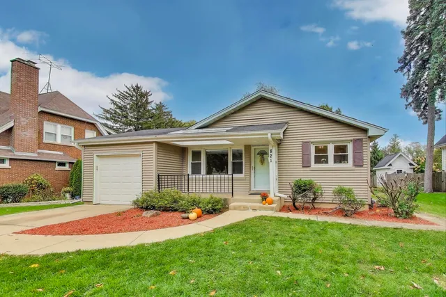 a front view of house with yard and green space