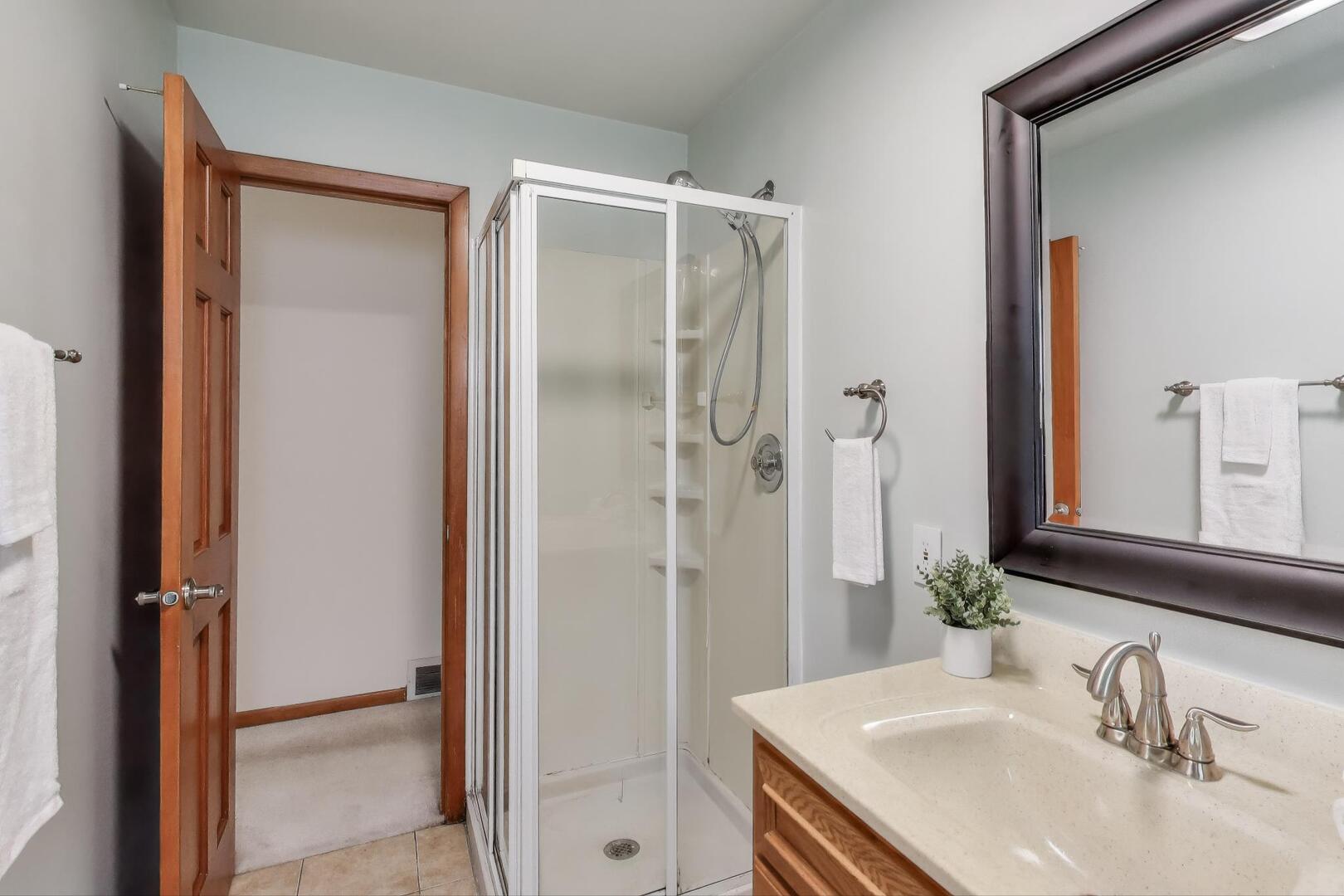 821 Warrenville Road Wheaton, IL 60189 - Photo 11 of 35 a bathroom with a shower sink and mirror