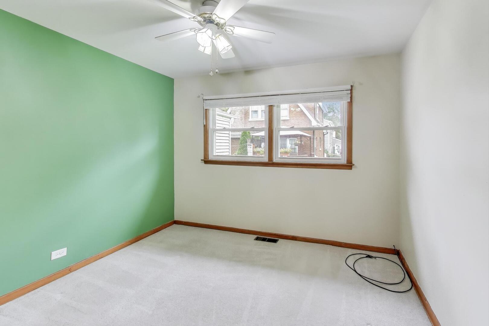 821 Warrenville Road Wheaton, IL 60189 - Photo 15 of 35 a view of a room with a ceiling fan and a window