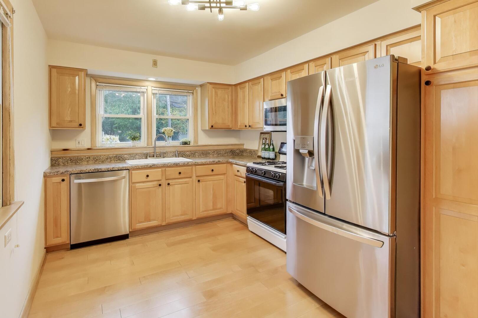 821 Warrenville Road Wheaton, IL 60189 - Photo 9 of 35 a kitchen with stainless steel appliances a refrigerator sink and cabinets