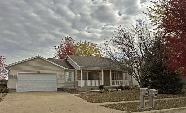 a kitchen with stainless steel appliances granite countertop a refrigerator a stove and a sink with wooden floor