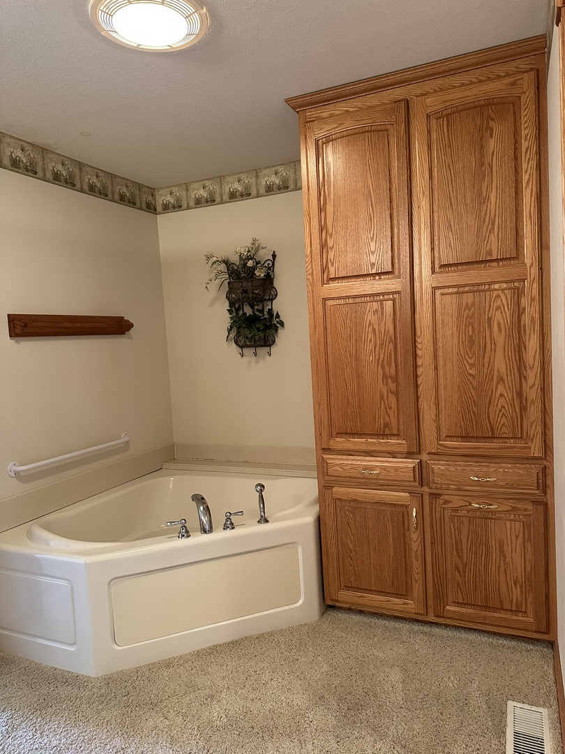 1005 North Fox Run Villa Grove, IL 61956 - Photo 24 of 45 a bathroom with a bathtub and shower