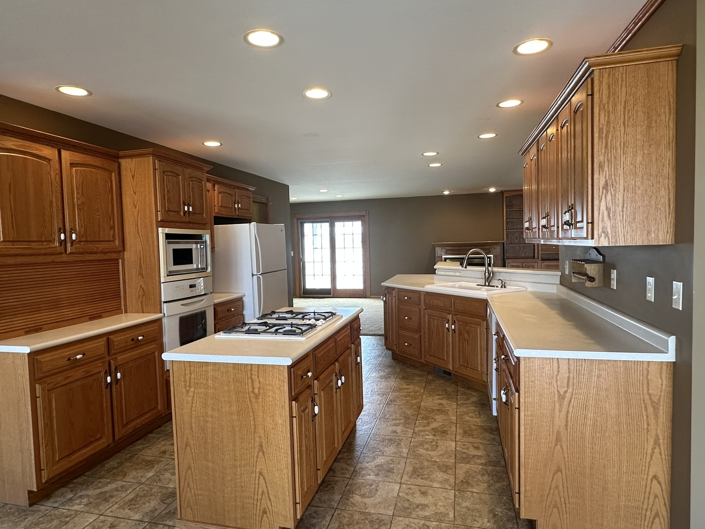 1005 North Fox Run Villa Grove, IL 61956 - Photo 5 of 45 a kitchen with stainless steel appliances granite countertop a stove a sink a refrigerator and a microwave