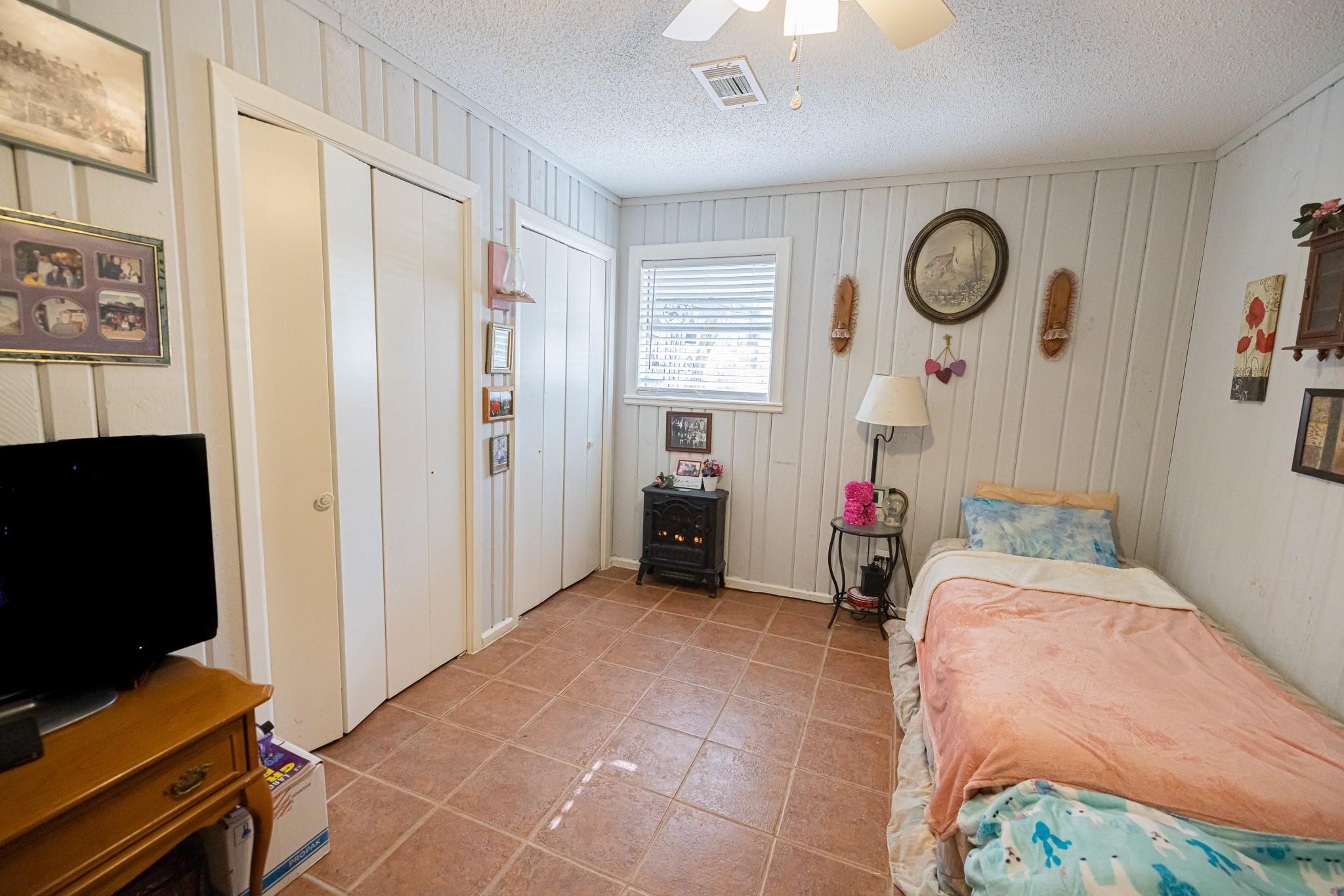 761 North Forest Cove Loop Coldspring, TX 77331 - Photo 14 of 33 a bedroom with filled bed and a window