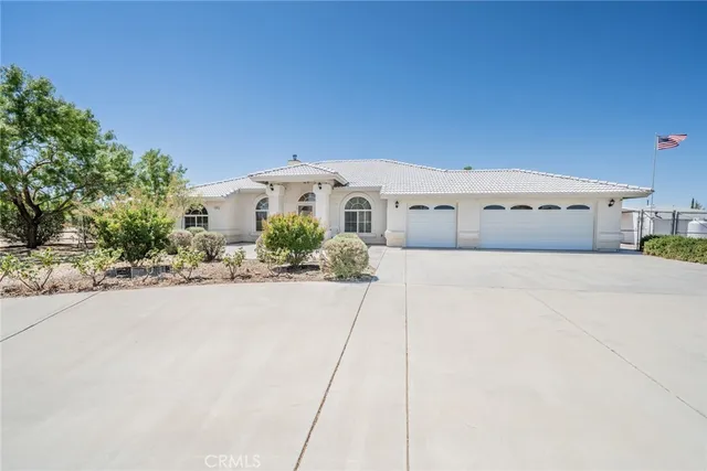 a front view of a house with a yard and a garage