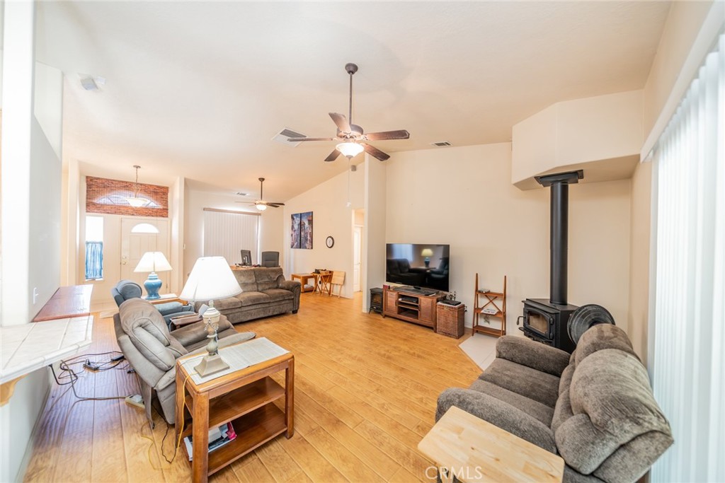 13880 Paramount Road Phelan, CA 92371 - Photo 14 of 54 a living room with furniture a fireplace and a flat screen tv