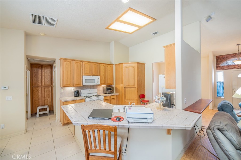 13880 Paramount Road Phelan, CA 92371 - Photo 16 of 54 a kitchen with a stove a sink and a refrigerator