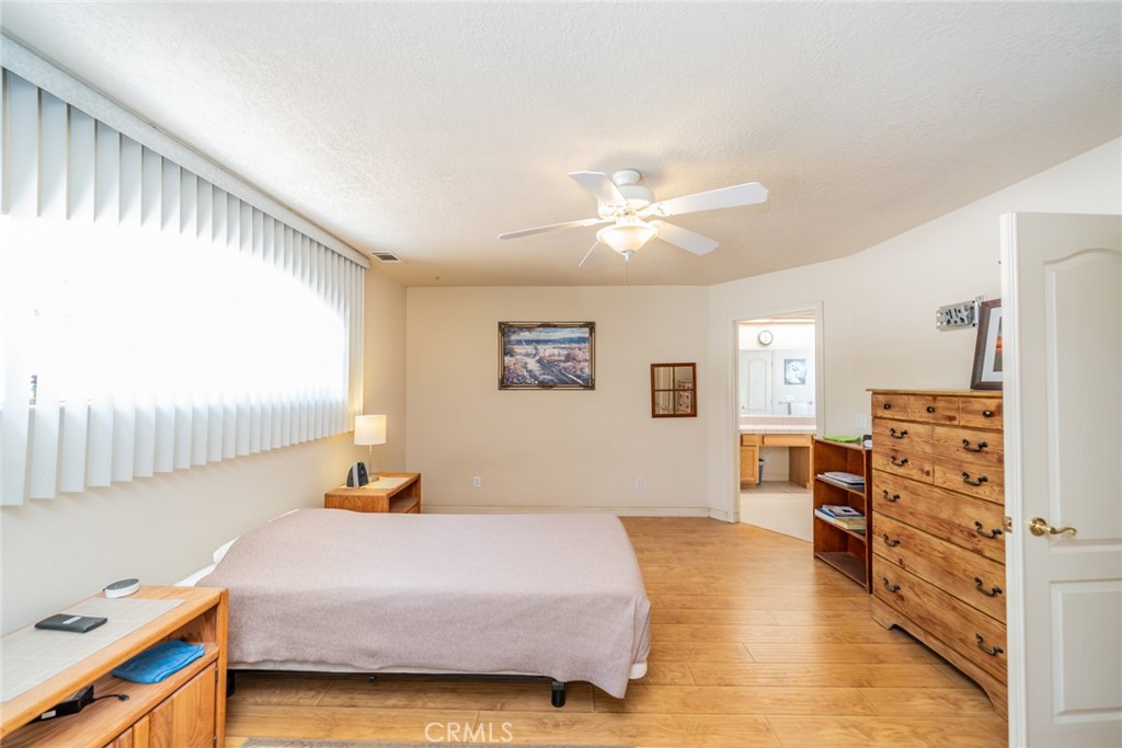 13880 Paramount Road Phelan, CA 92371 - Photo 18 of 54 a bedroom with a bed and dresser