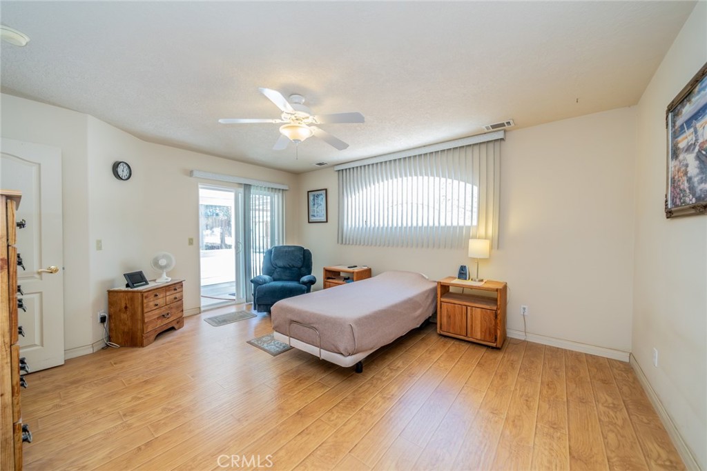 13880 Paramount Road Phelan, CA 92371 - Photo 20 of 54 a bedroom with a bed and window