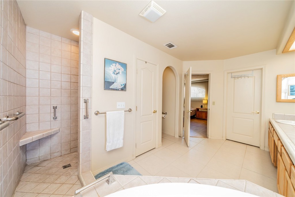 13880 Paramount Road Phelan, CA 92371 - Photo 22 of 54 a spacious bathroom with a shower and a sink