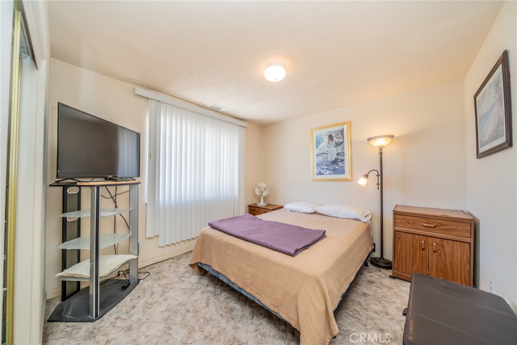 13880 Paramount Road Phelan, CA 92371 - Photo 27 of 54 a bedroom with a bed and a flat screen tv