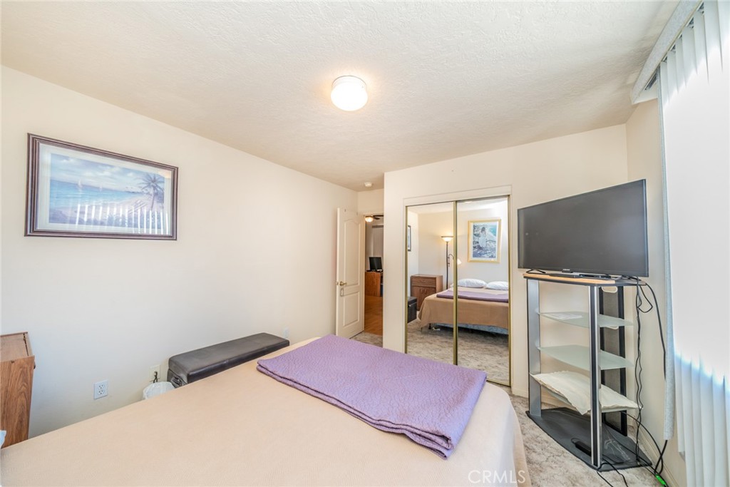 13880 Paramount Road Phelan, CA 92371 - Photo 28 of 54 a bedroom with a bed and a flat screen tv