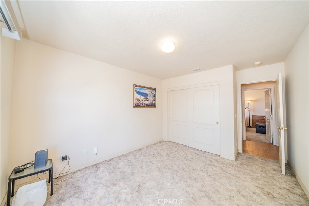 13880 Paramount Road Phelan, CA 92371 - Photo 32 of 54 an empty room with closet