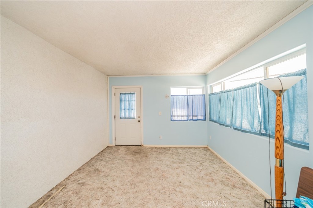 13880 Paramount Road Phelan, CA 92371 - Photo 35 of 54 a view of a storage & utility room with a window