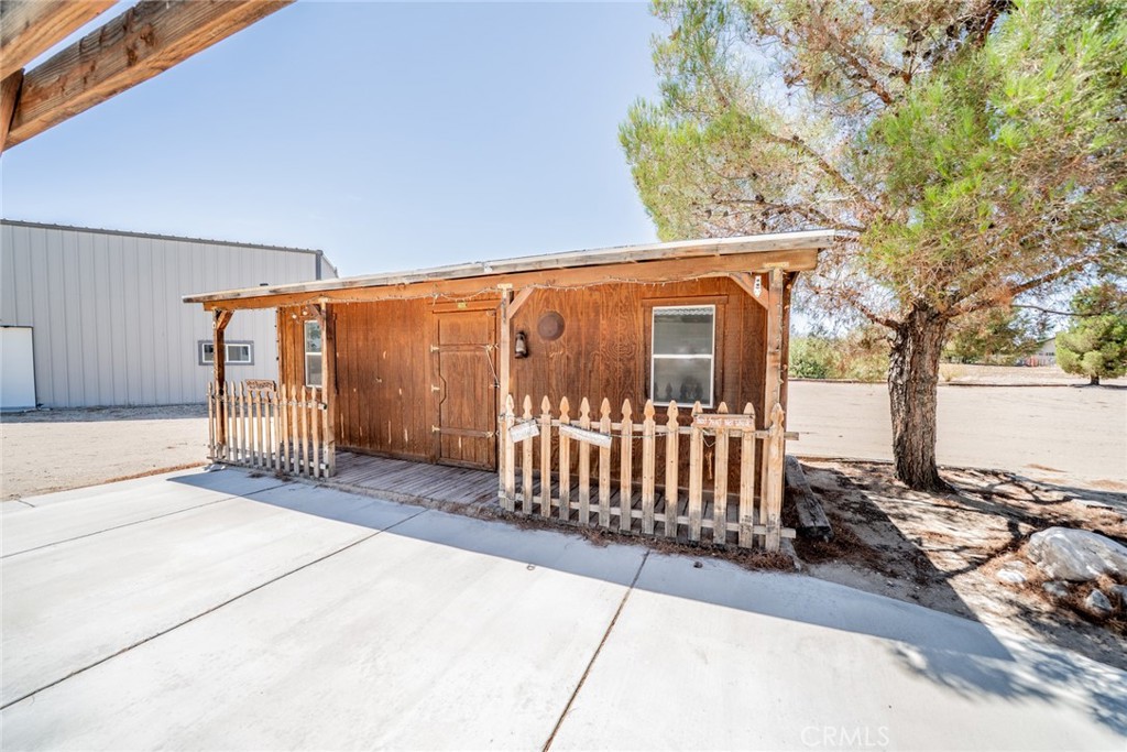 13880 Paramount Road Phelan, CA 92371 - Photo 36 of 54 a view of a porch with a bench