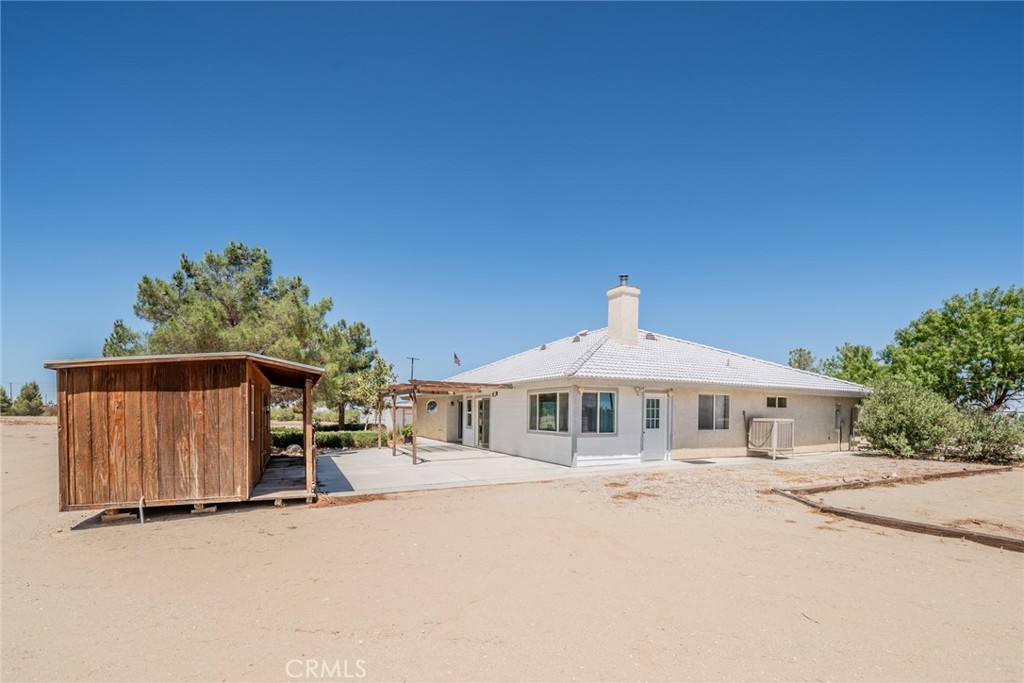 13880 Paramount Road Phelan, CA 92371 - Photo 43 of 54 a front view of a house with a yard