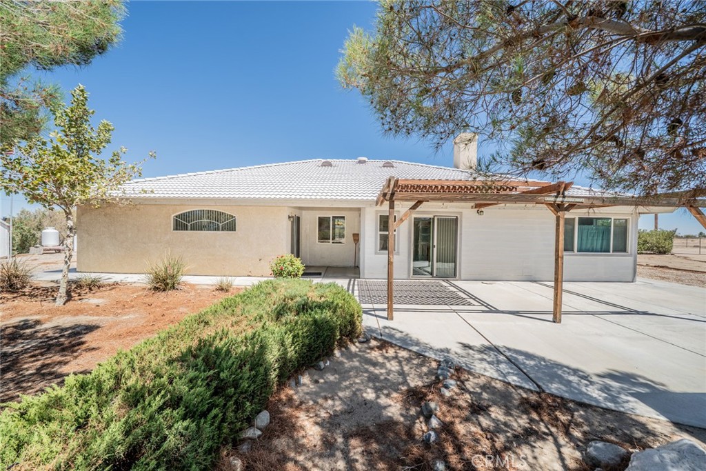 13880 Paramount Road Phelan, CA 92371 - Photo 48 of 54 a view of a house with a tree in front of it