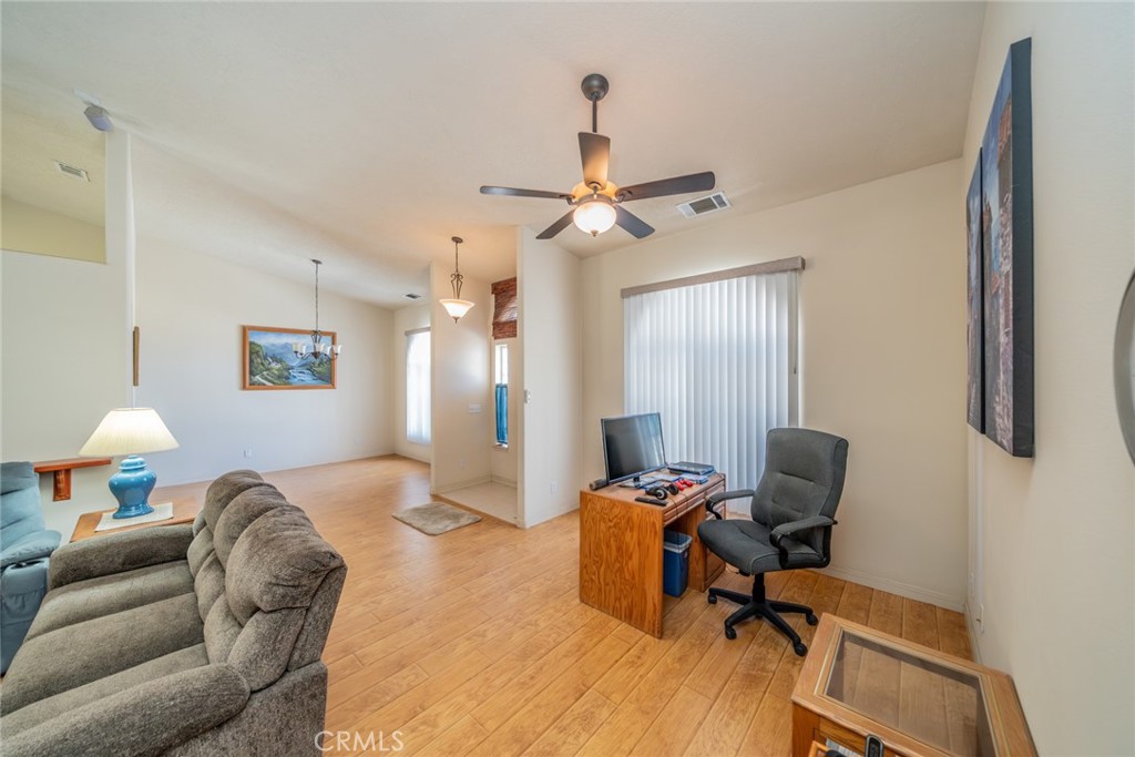 13880 Paramount Road Phelan, CA 92371 - Photo 7 of 54 a livingroom with workspace couch and a window