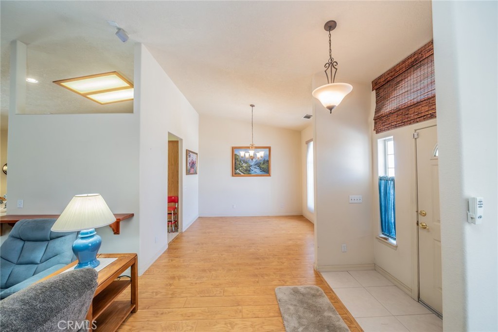 13880 Paramount Road Phelan, CA 92371 - Photo 8 of 54 a bedroom with bed and a chandelier