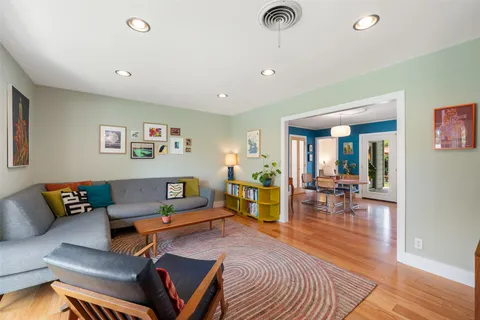 a living room with furniture and wooden floor