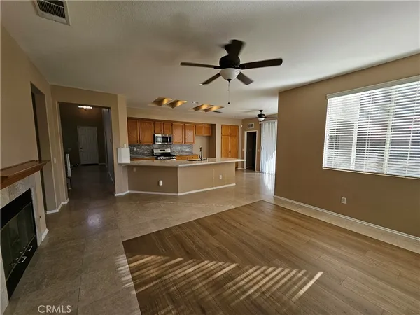 a kitchen with stainless steel appliances kitchen island granite countertop a refrigerator and microwave