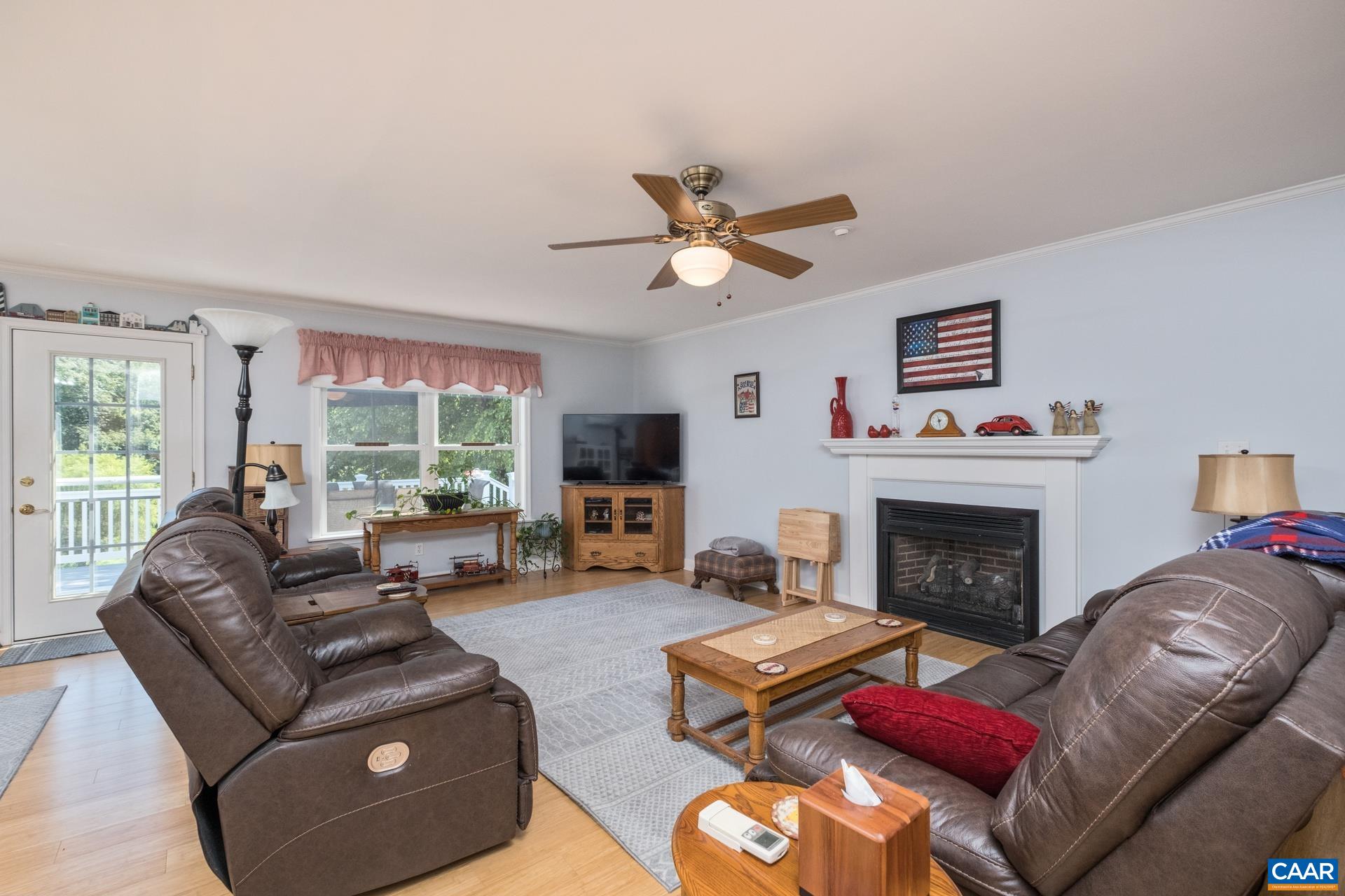 162 Rolling Hills Road Ruckersville, VA 22968 - Photo 21 of 48 a living room with furniture a large window and a fireplace