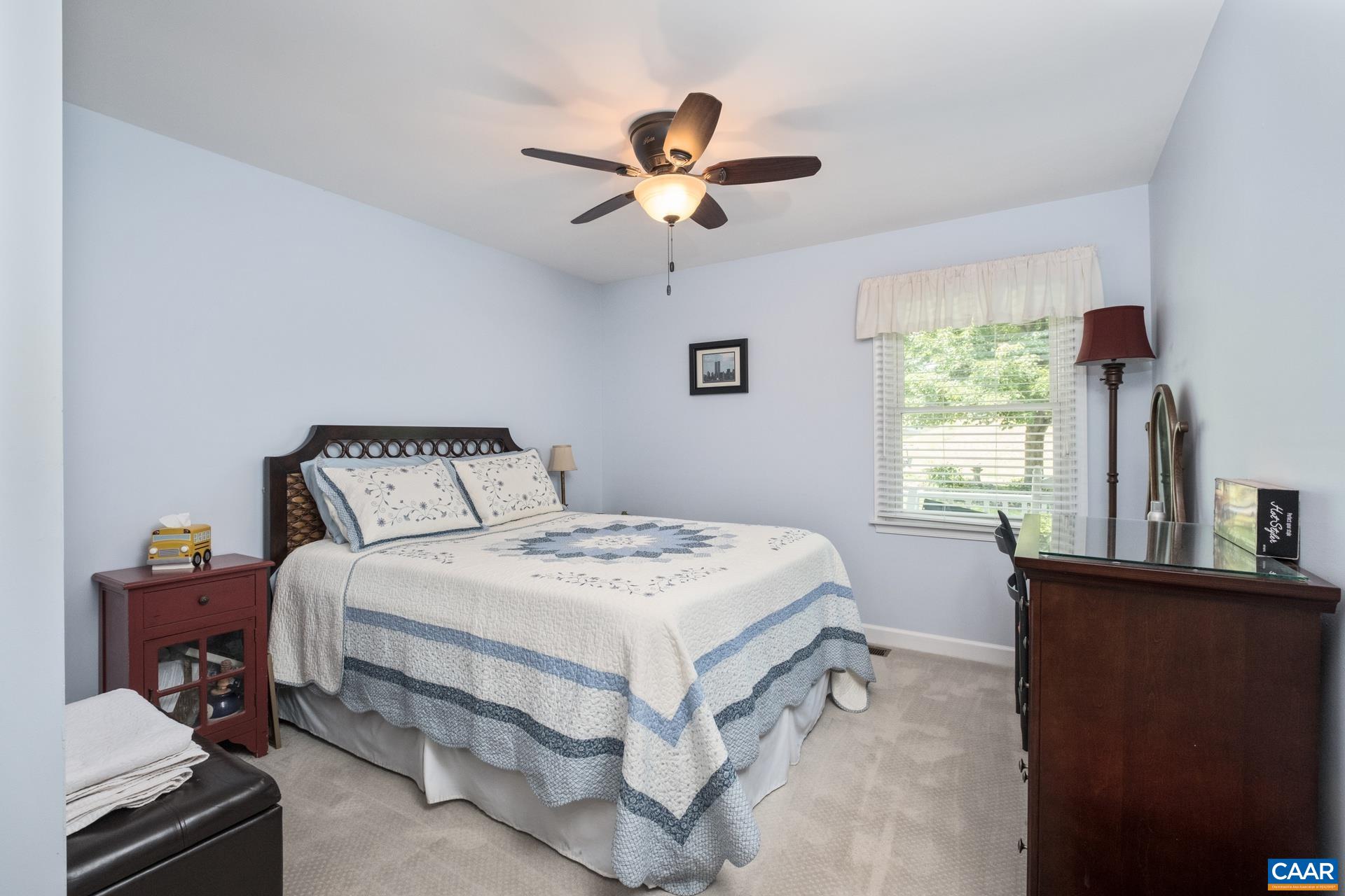 162 Rolling Hills Road Ruckersville, VA 22968 - Photo 29 of 48 a bedroom with a bed and a chandelier