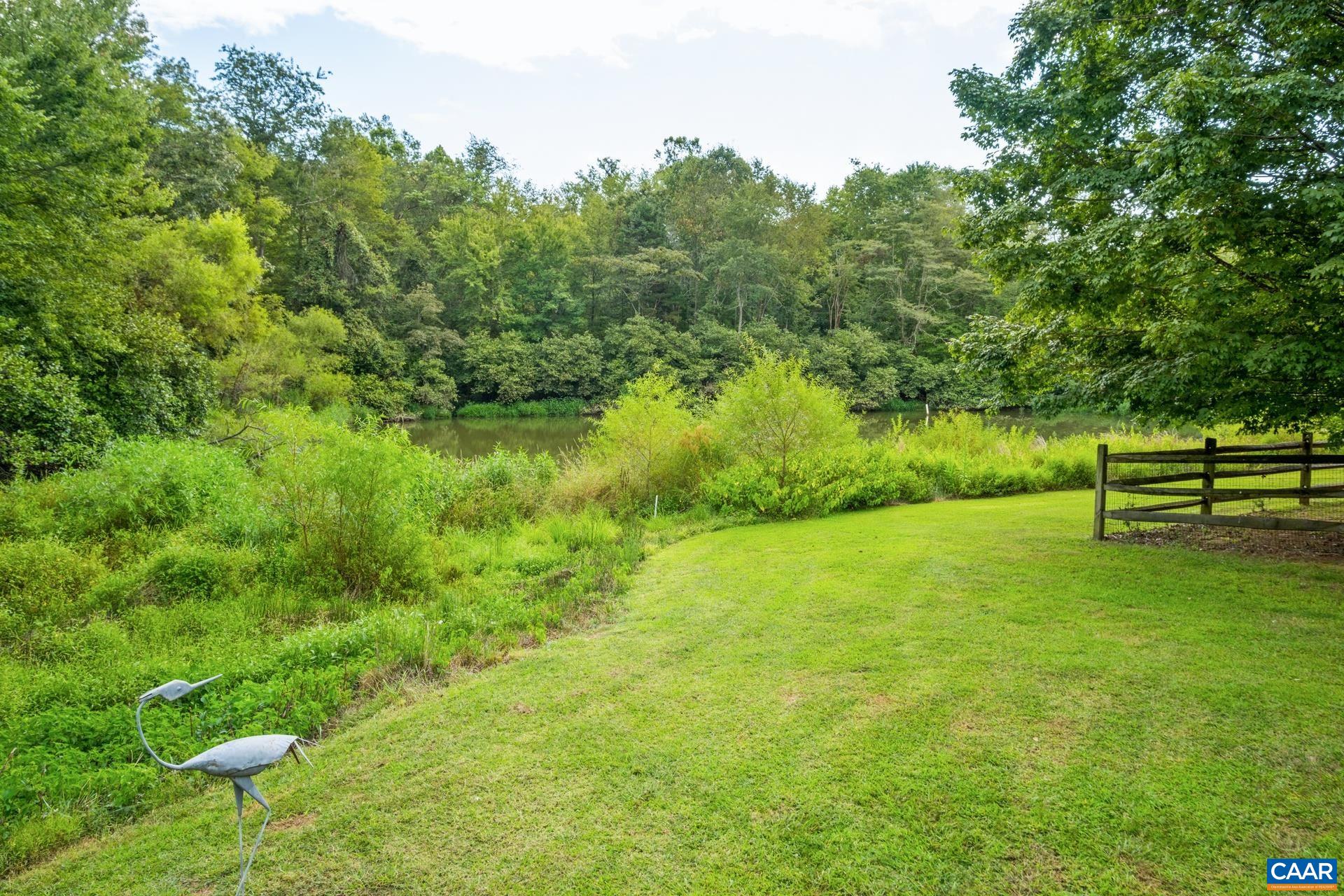 162 Rolling Hills Road Ruckersville, VA 22968 - Photo 39 of 48 a view of a garden with a bench and trees
