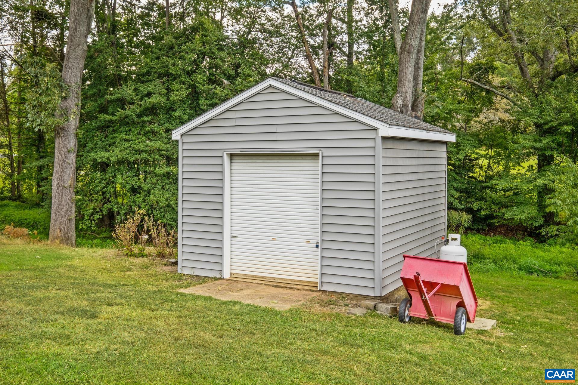 162 Rolling Hills Road Ruckersville, VA 22968 - Photo 42 of 48 a view of a backyard with plants and large tree