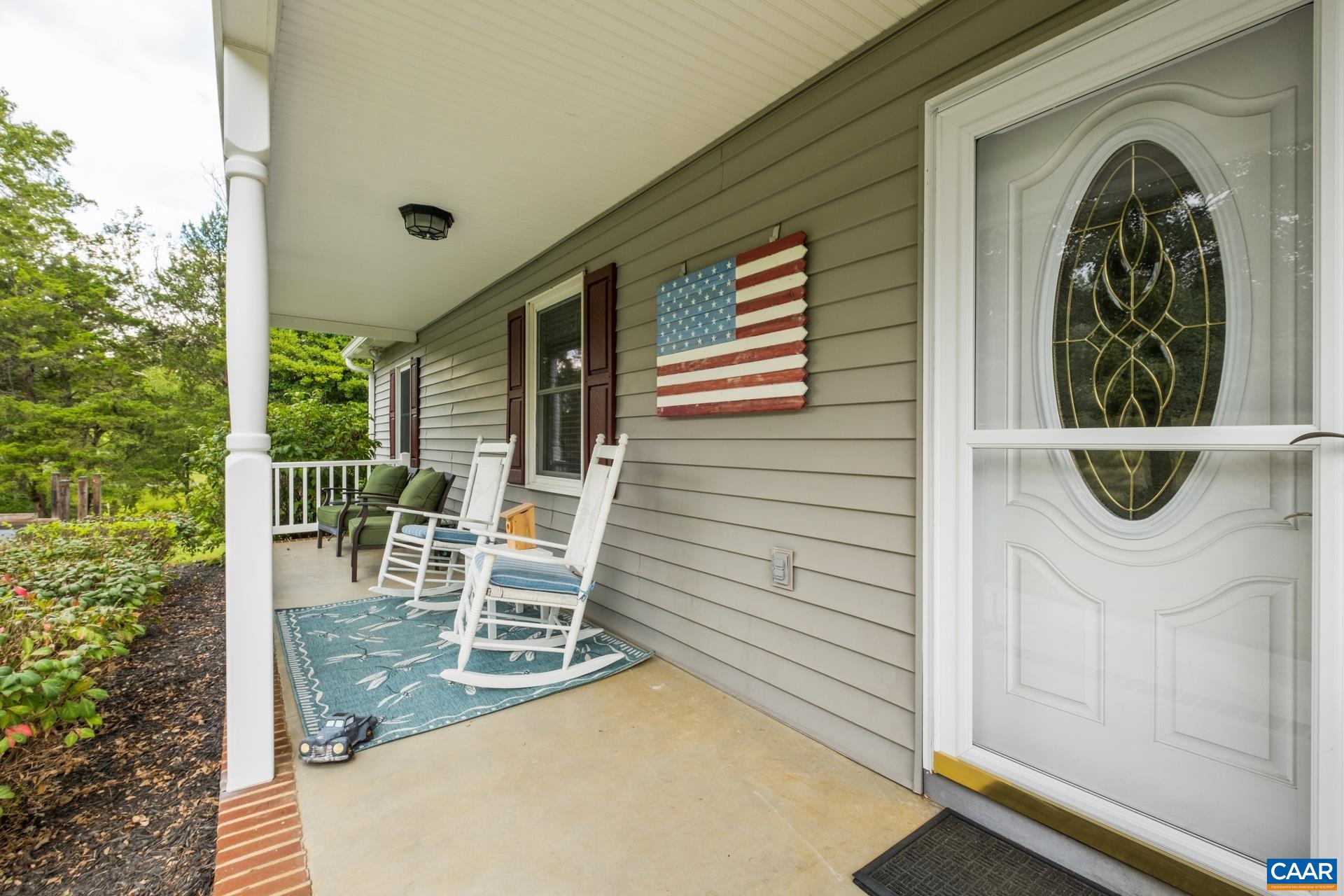162 Rolling Hills Road Ruckersville, VA 22968 - Photo 6 of 48 a view of a porch with chairs and potted plants