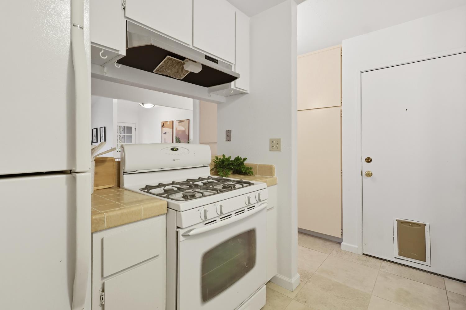 2526 Overhill Lane Davis, CA 95616 - Photo 26 of 60 a kitchen with stainless steel appliances granite countertop a stove a refrigerator and a cabinets