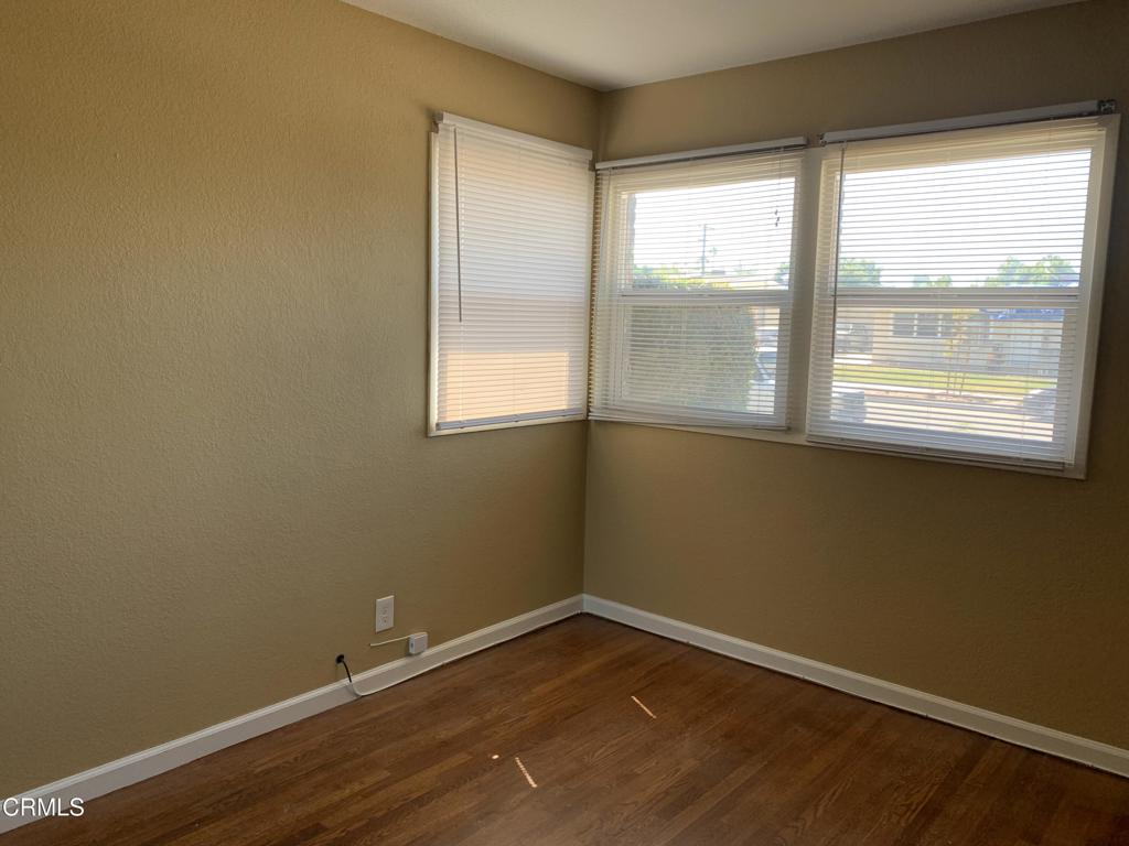 938 Ford Street Corona, CA 92879 - Photo 11 of 36 a view of an empty room with wooden floor and a window