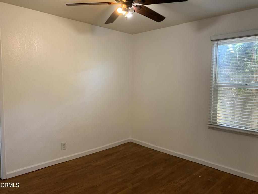 938 Ford Street Corona, CA 92879 - Photo 12 of 36 en empty room with wooden floor and windows