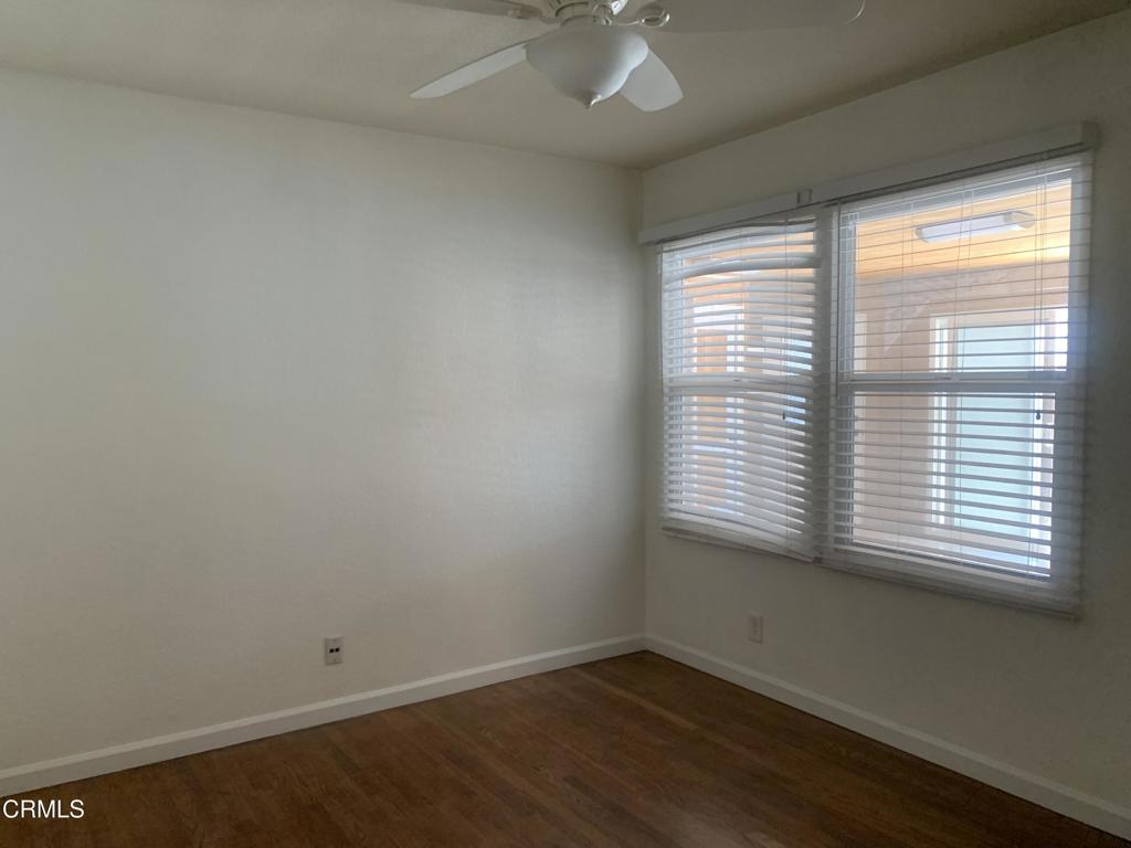 938 Ford Street Corona, CA 92879 - Photo 13 of 36 a view of an empty room with wooden floor and a window