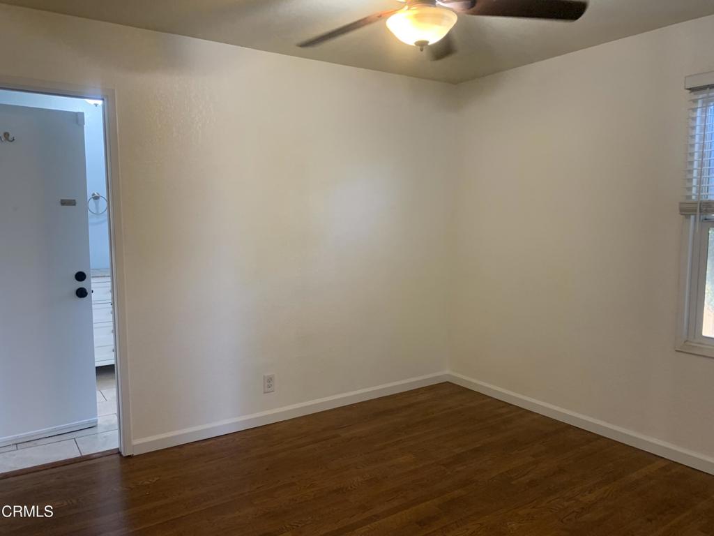 938 Ford Street Corona, CA 92879 - Photo 14 of 36 a view of an empty room with wooden floor and a window