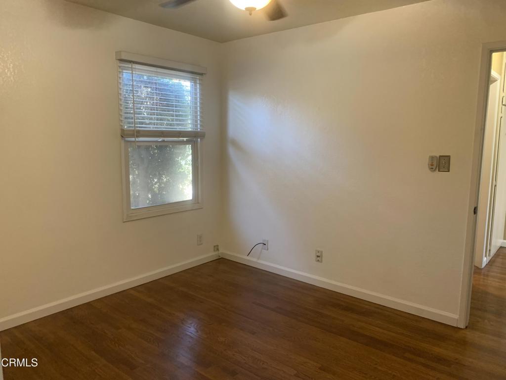 938 Ford Street Corona, CA 92879 - Photo 15 of 36 an empty room with wooden floor and windows