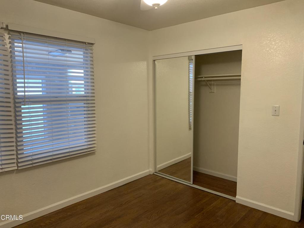 938 Ford Street Corona, CA 92879 - Photo 16 of 36 a view of an empty room with wooden floor and a window