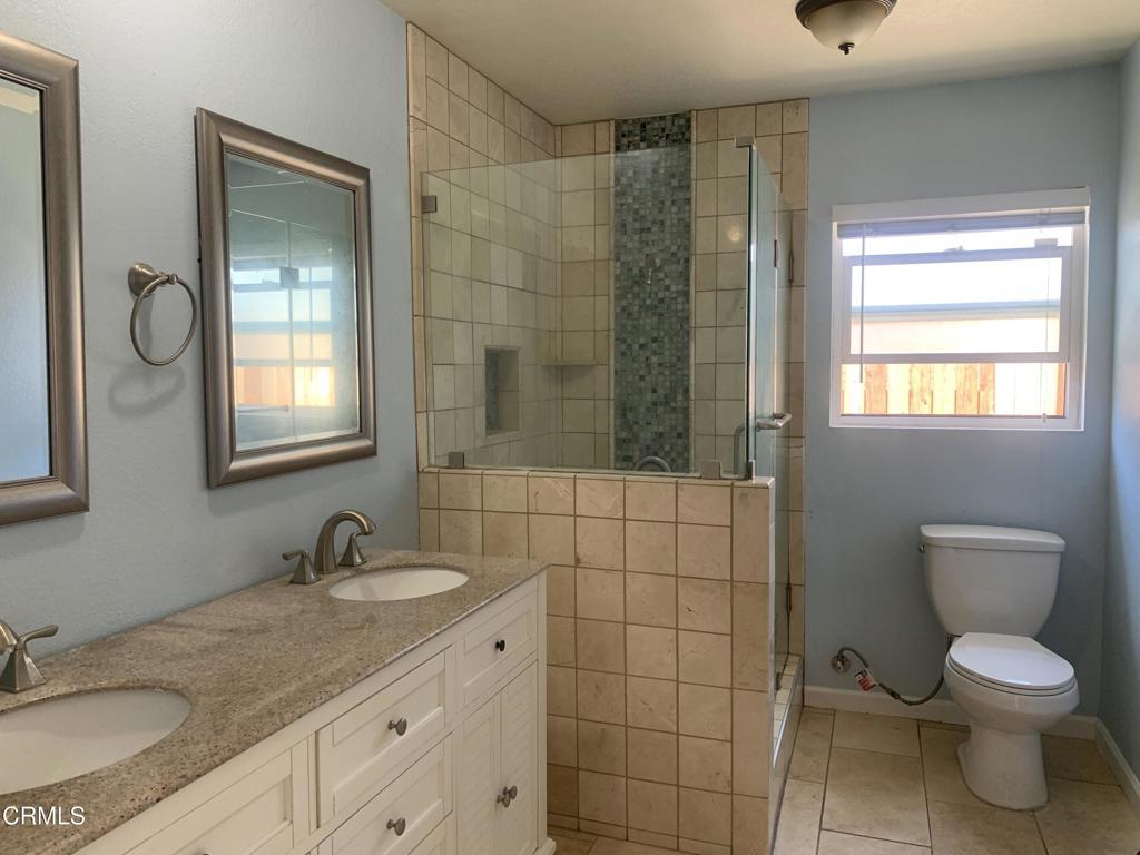 938 Ford Street Corona, CA 92879 - Photo 19 of 36 a bathroom with a granite countertop sink toilet and shower
