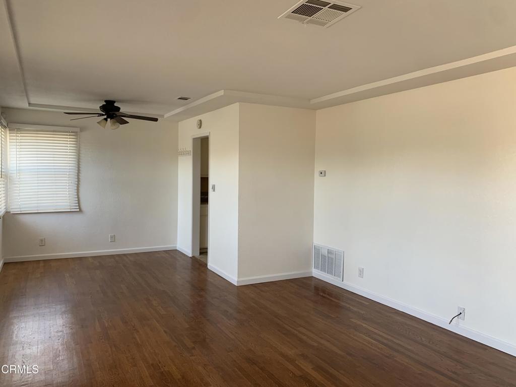 938 Ford Street Corona, CA 92879 - Photo 3 of 36 a view of a room with wooden floor and a ceiling fan