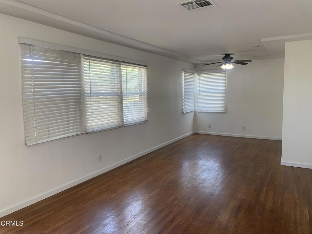 938 Ford Street Corona, CA 92879 - Photo 4 of 36 an empty room with wooden floor and windows
