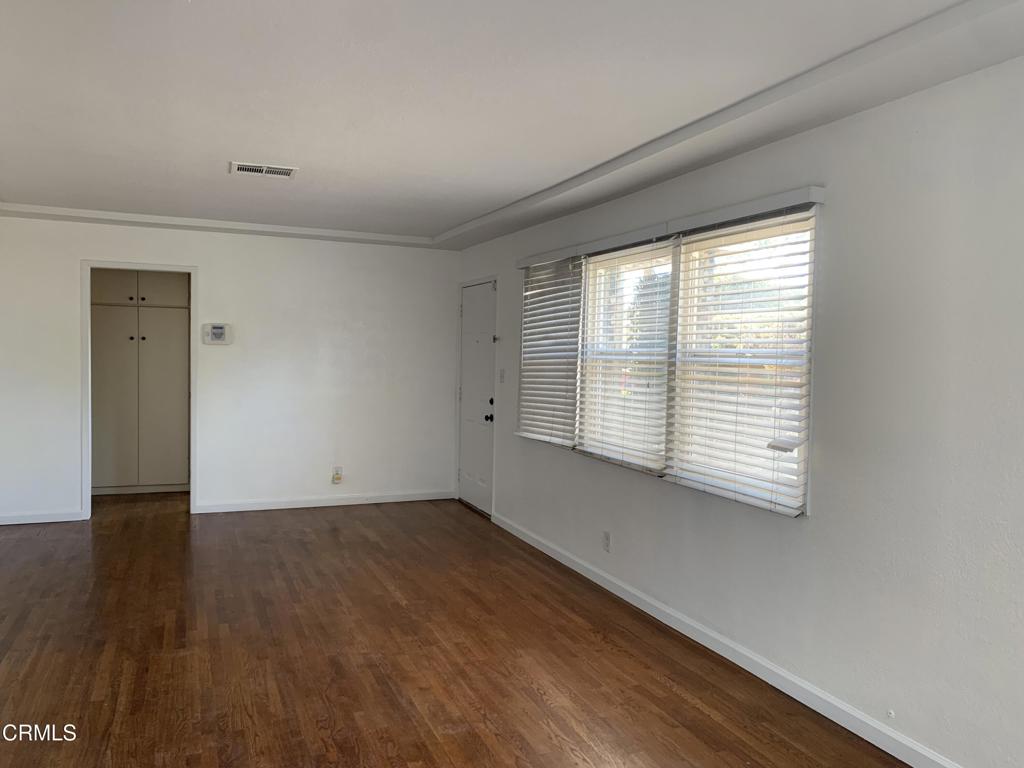 938 Ford Street Corona, CA 92879 - Photo 5 of 36 a view of an empty room with wooden floor and a window